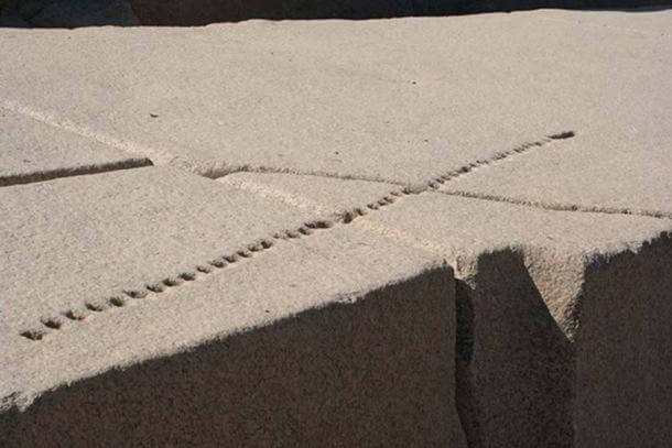 An unfinished Egyptian obelisk at Aswan with holes showing how the granite would be split.