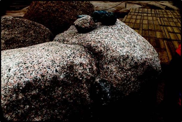 Dolorite pounders on top of a piece of pink Aswan granite.