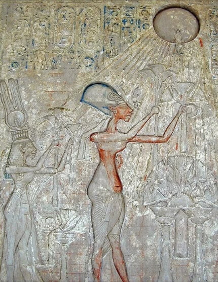 Akhenaten and his family worshipping Aten, and being touched by the rays from the sun disc.