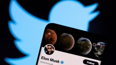 Elon Musk's Twitter account is seen on a smartphone in front of the Twitter logo in this photo illustration taken on April 15, 2022. (Dado Ruvic/Illustration/Reuters)