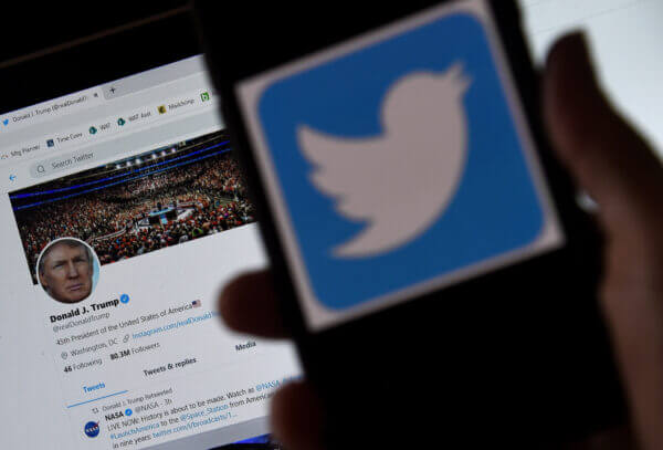 In this photo illustration, a Twitter logo is displayed on a mobile phone with President Donald Trump’s Twitter page shown in the background in Arlington, Va., on May 27, 2020. (Olivier Douliery/AFP via Getty Images)