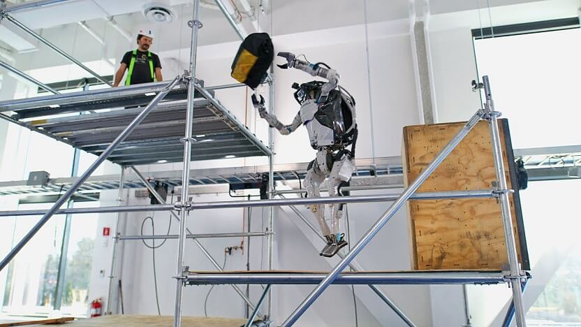 Watch A Boston Dynamics Robot Deftly Toss A Bag of Tools To A Construction Worker