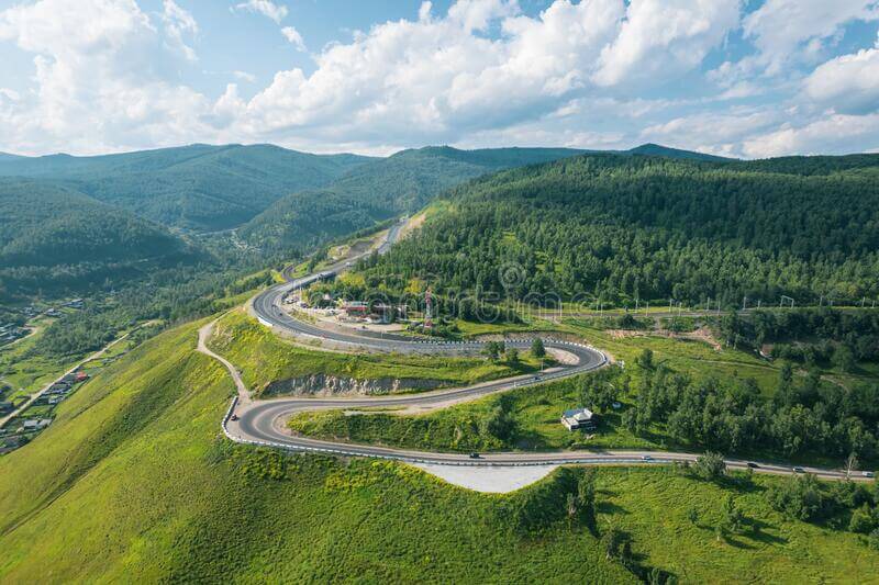 This aerial view shows a mountain valley in Kultuk, Slyudyanka, Russia, traversed by the serpentine Trans-Siberian Highway. QUATROX PRODUCTION/SHUTTERSTOCK