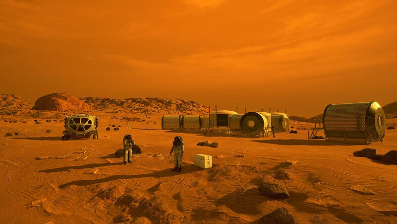 This artist’s concept depicts astronauts and human habitats on Mars.
