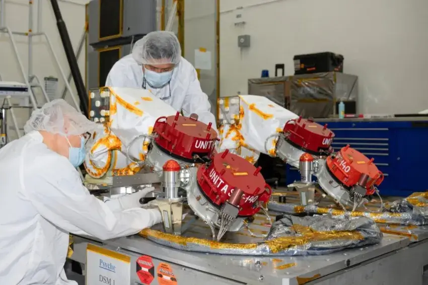 Engineers preparing to install Psyche’s four Hall thrusters. Credit: ASA / JPL-Caltech