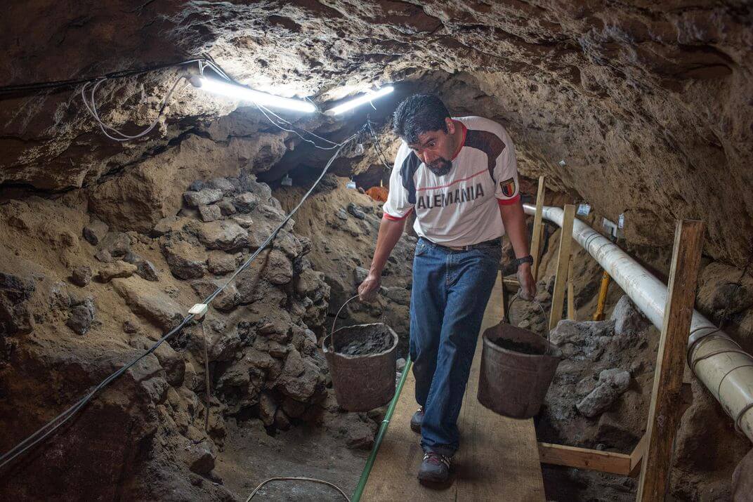 Workers removing dirt in a tunnel under the Pyramid of the Feathered Serpent, Teotihuacán. 
