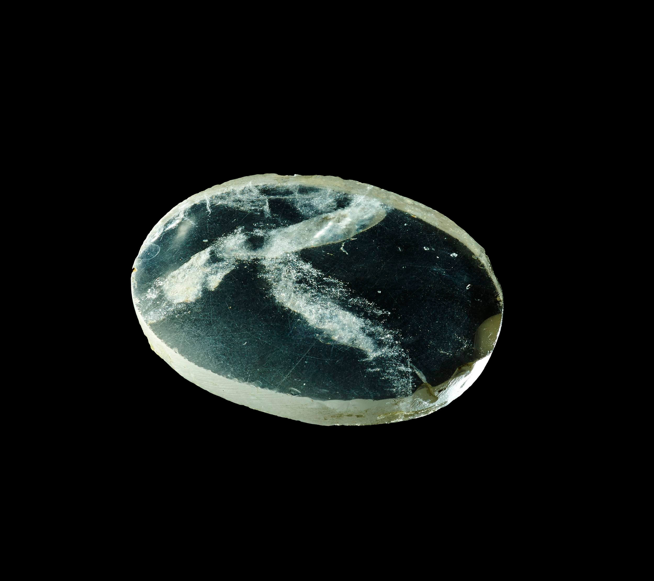 Oval rock-crystal inlay: ground and polished, with one plane and one slightly convex face. It has been regarded as an optical lens but would have been of little or no practical use. © The British Museum