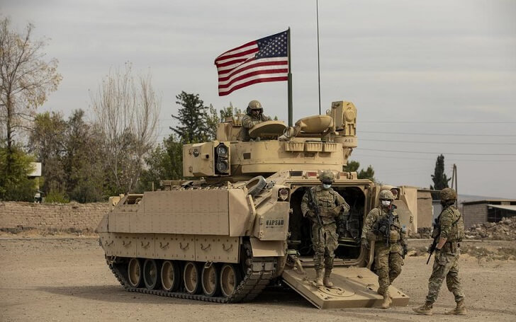 U.S. soldiers with the 1st Armored Division dismount from their M2 Bradley