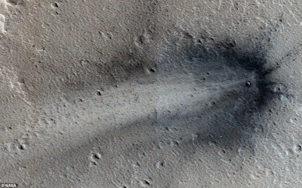 Does this image from NASA’s MRO really show a crashed UFO on the surface of Mars? Notice the mysterious disk-shaped object at the centre.