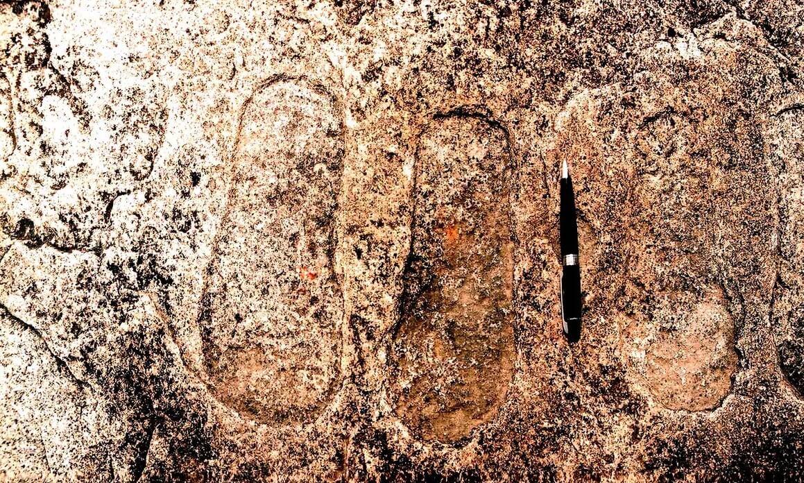 Footprints on a rock in Piska Nagri village, on the outskirts of Ranchi City in Jharkahnd State, India. Probably thousands of years old, these footprints are engraved on granite rock by the earlier inhabitants of the area and are believed by the locals to be those of king gods Rama and Lakshmana.