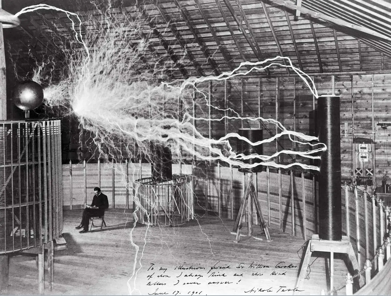 Publicity photo of Nikola Tesla in his laboratory in Colorado Springs, Colorado, in December 1899. Tesla posed with his “magnifying transmitter,” which was capable of producing millions of volts of electricity. The discharge shown is 6.7 metres (22 feet) in length.