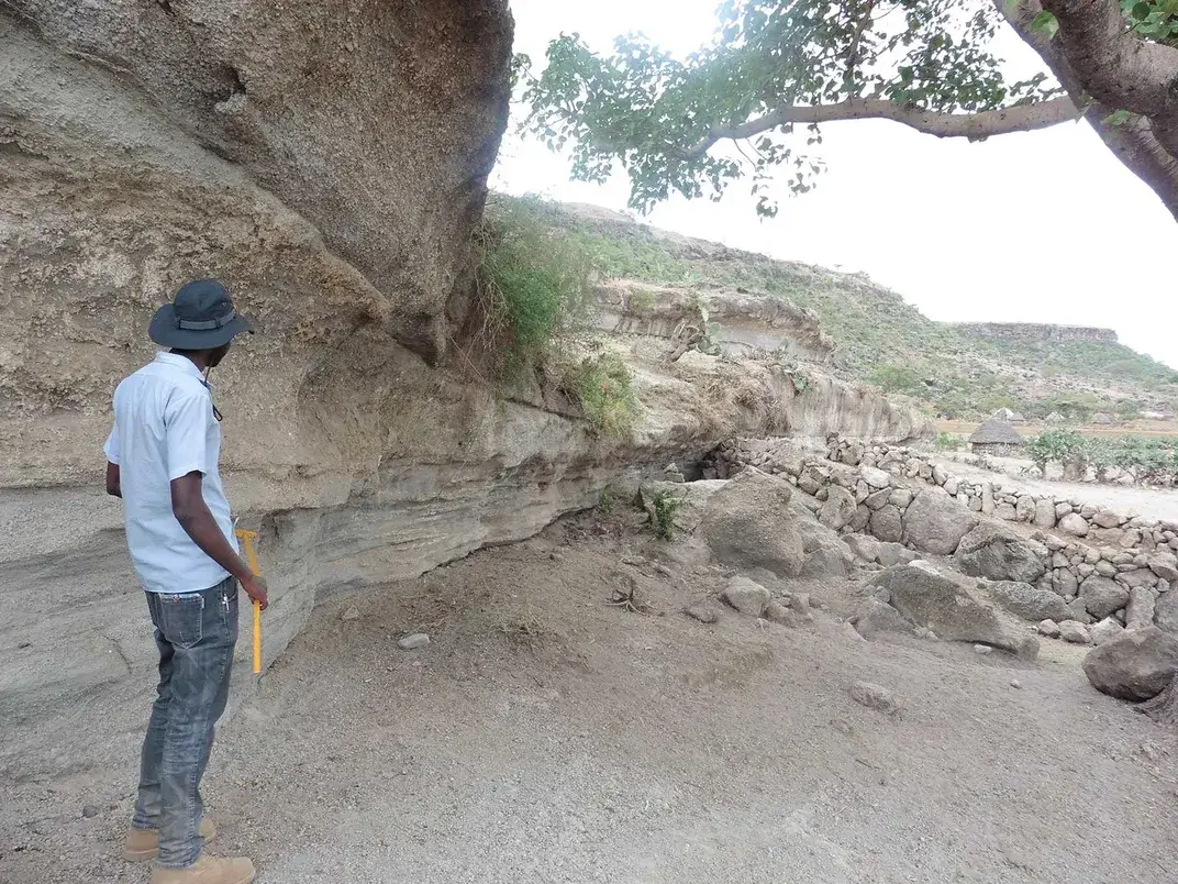 Geologist Amdemichael Zafu, a study coauthor, in front of the deposits of the 233,000-year-old eruption of Shala. Céline Vidal