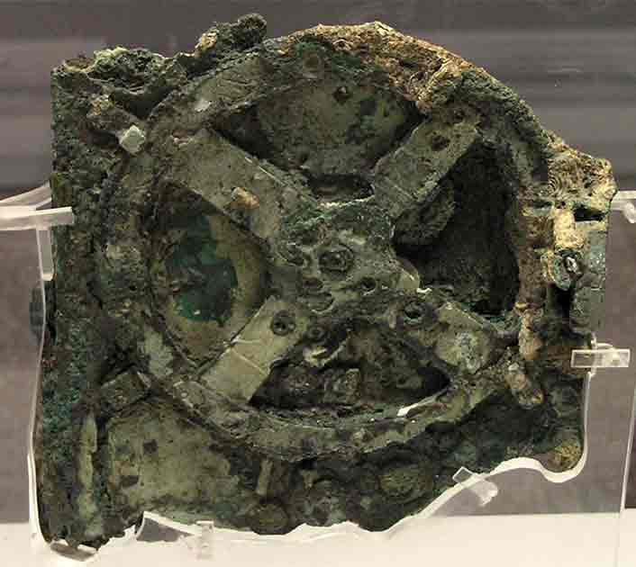 Top image: An ancient “computer”: the Antikythera mechanism (fragment A – front and rear); visible is the largest gear in the mechanism, about 13 cm (5 in) in diameter.
