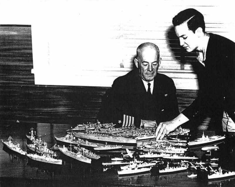 Seventeen-year-old Bill Tompkins points out the detail on his models to naval Captain H. C. Gearing, commandant of the 11th Naval District in San Diego. Bill was soon inducted into the navy and is shown in the second photo in his uniform holding one of his aircraft carriers. He went on to help design com on the real ships. © Tompkins