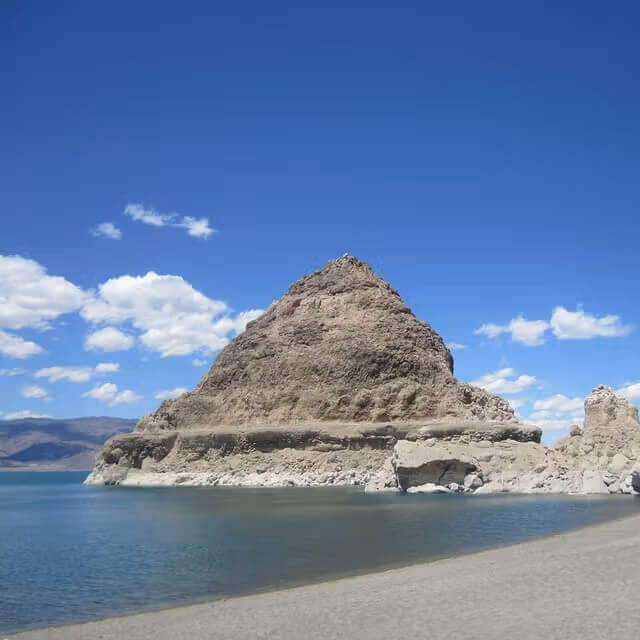 Ancient tufa pyramid formation rising from the waters of Pyramid Lake in Nevada, a geological remnant of Lake Lahontan.