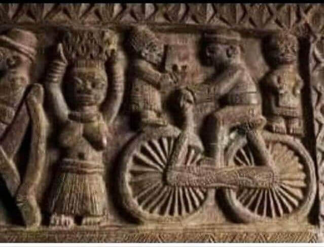 Ancient Indian temple carving depicting a figure riding a bicycle, sparking curiosity about its origins.