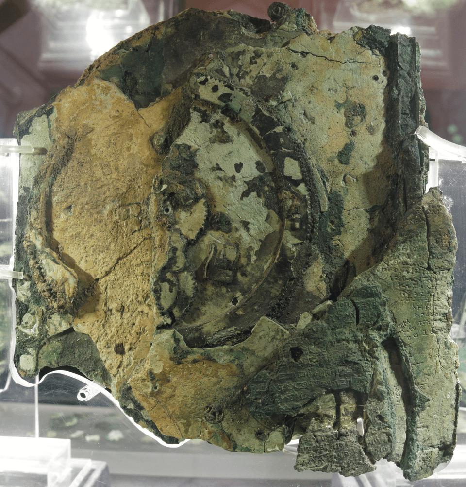 The Antikythera mechanism (fragment A – front and rear); visible is the largest gear in the mechanism, about 13 cm (5 in) in diameter.