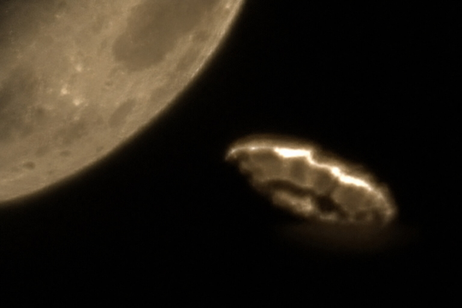 A glowing unidentified object appearing near the Moon against a black space background.