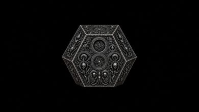 Ornate silver alien artifact with symmetrical engraved geometric designs