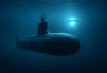 Submarine encountering an unidentified flying object underwater in the ocean.